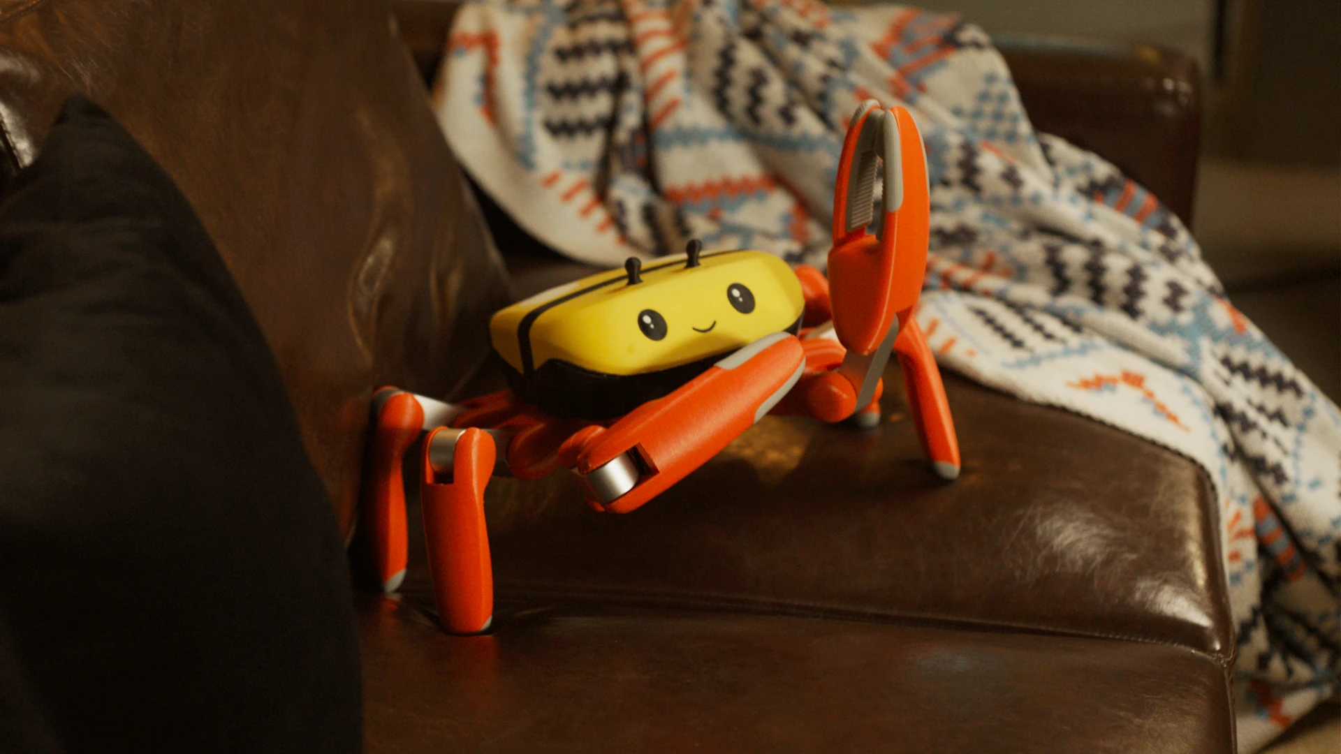 Jumper crab robot with a yellow smiling shell